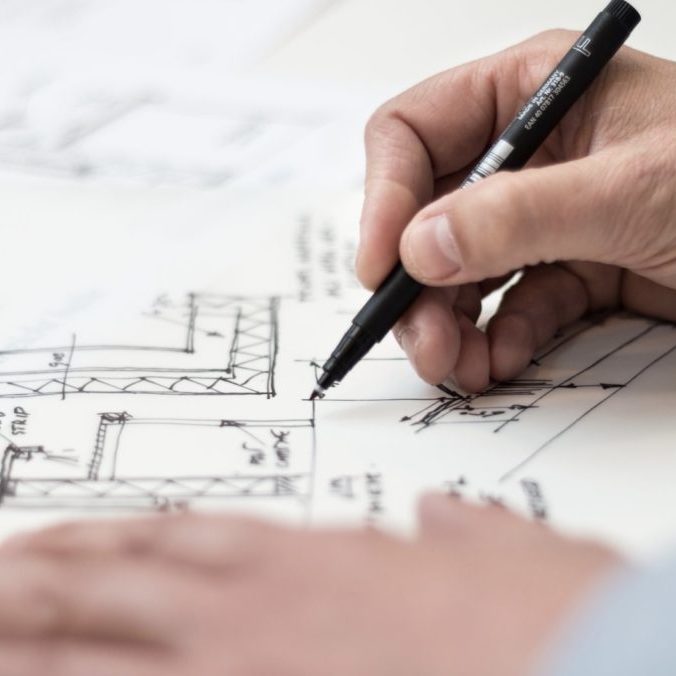 architect writing on a technical drawing